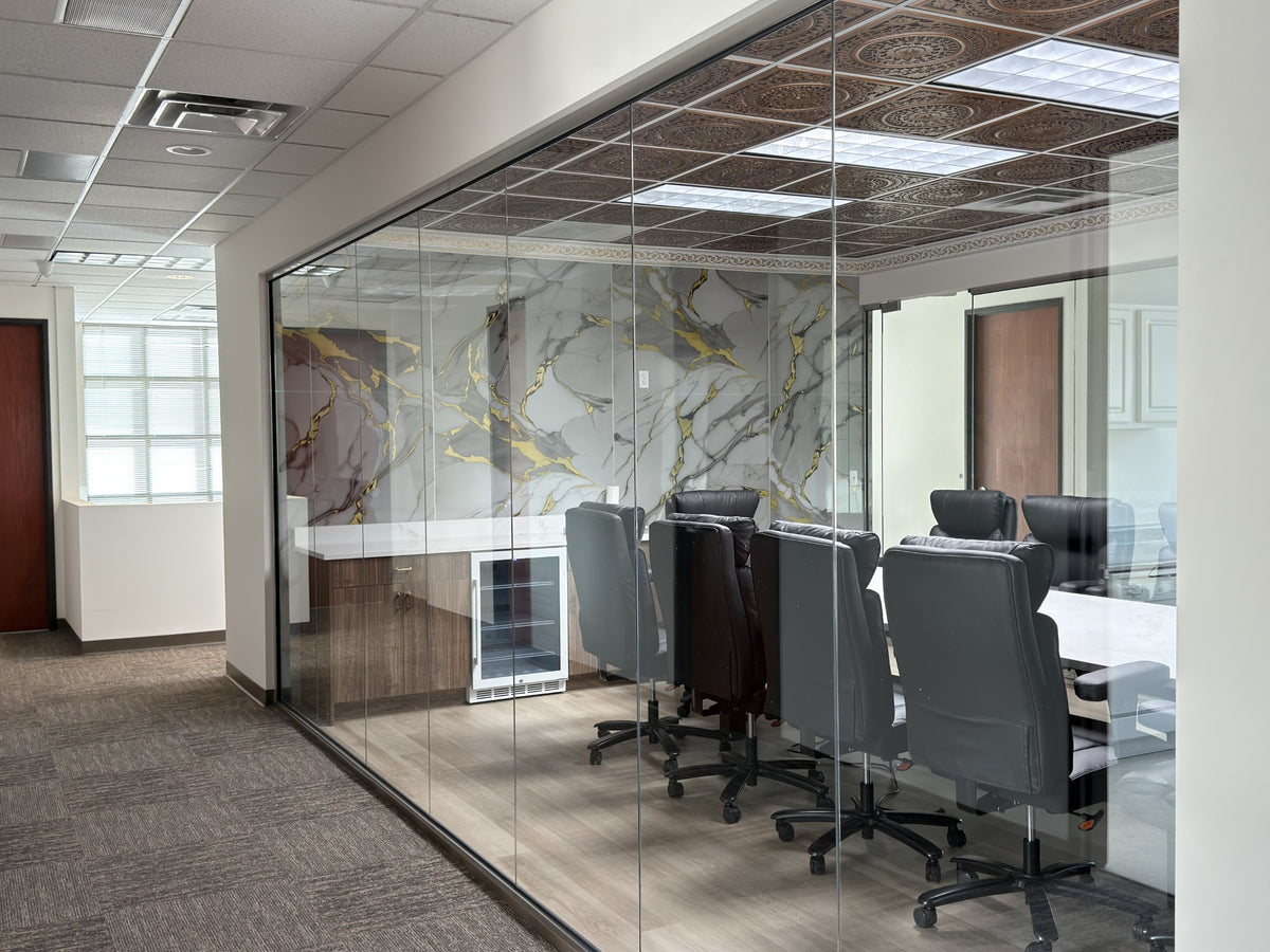Modern office conference room with glass walls and a meeting table before window film application