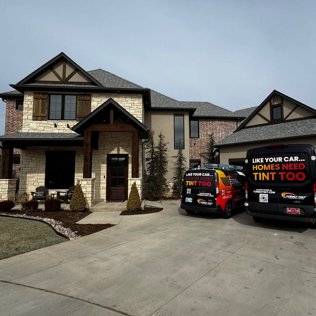 Turbo Tint architectural vans infront of a tined home