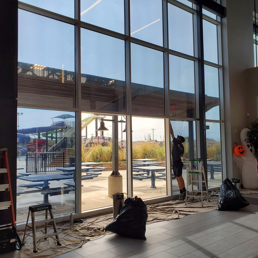 building with large glass panels being tinted by turbo tint at a waterpark to block heat into the building for a coller feel while keeping the views 