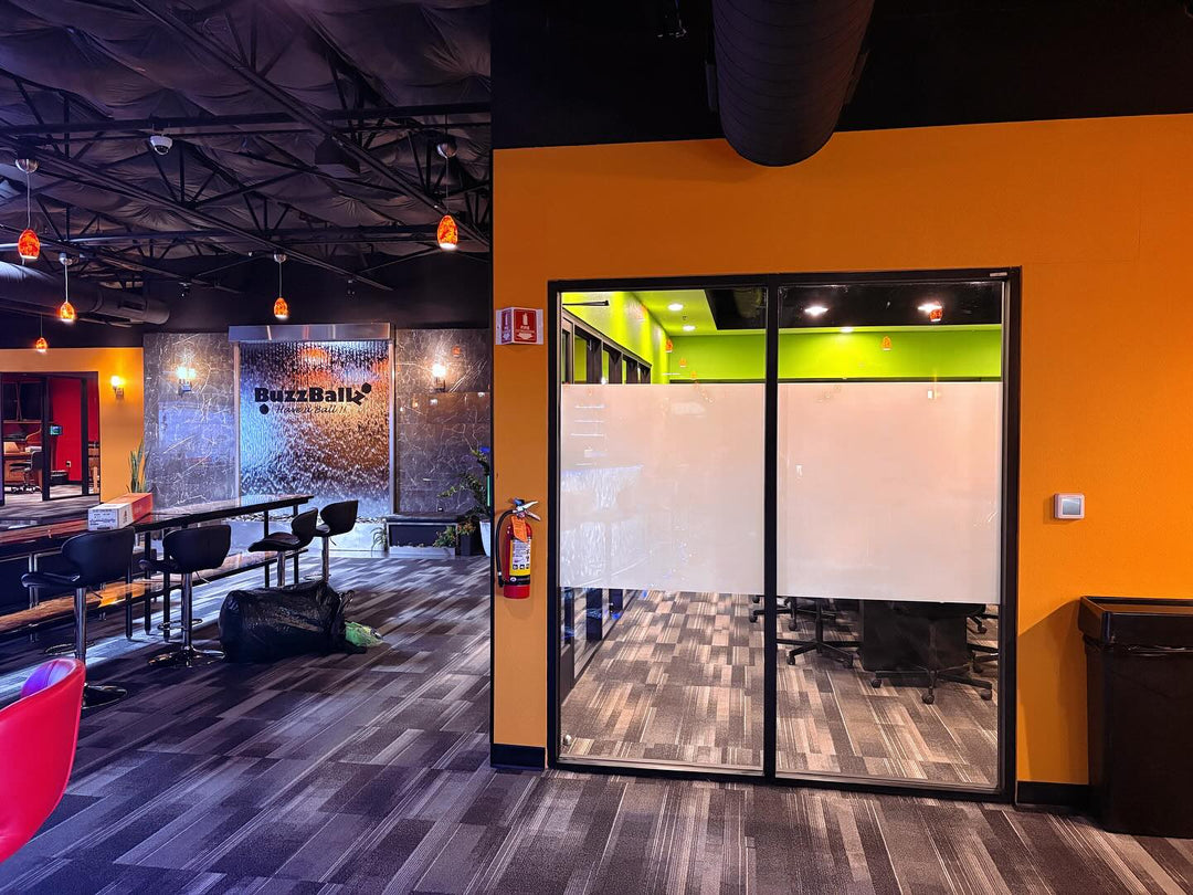 Modern office interior with colorful walls and glass partitions with window film from turbo tint for decor and privacy into the conference room