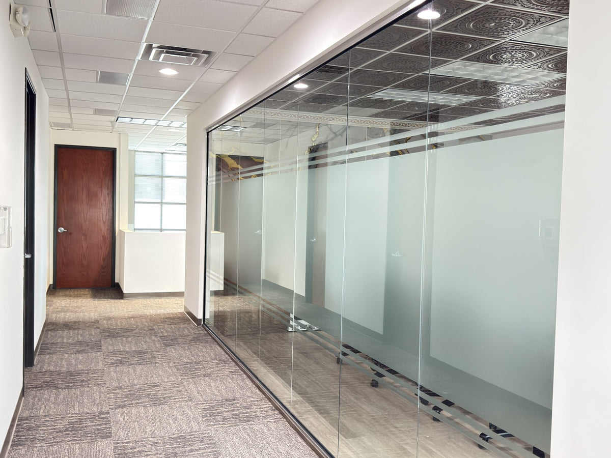 Modern office hallway with glass-walled offices and a wooden door at a business conference room for decor and privacy 