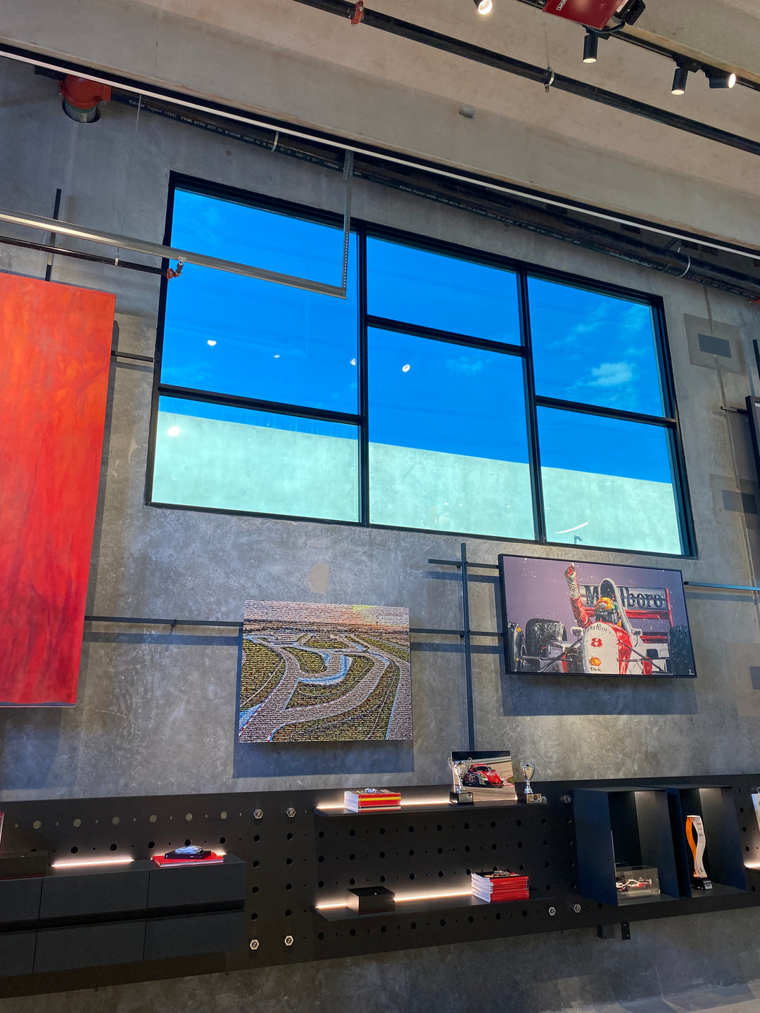 Modern interior with large glass window, artwork on the wall, and decorative window film for retail stores, museums, and more 