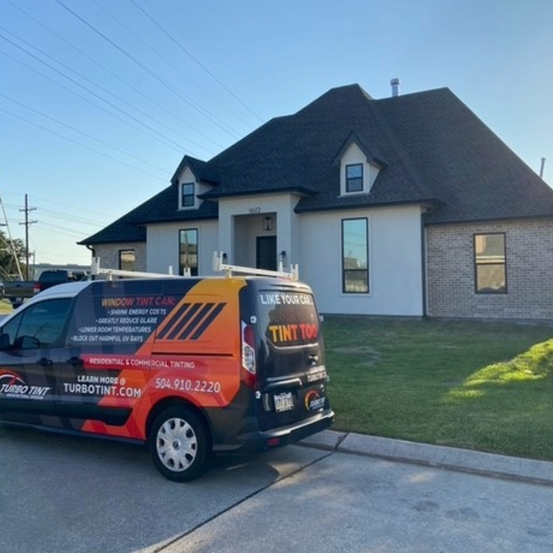 Turbo Tint van parked in front of a house with clear blue sky for turbo tint reflective window tint installation